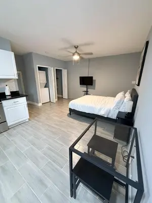 a bedroom with a bed and a table in it at Cozy Modern Studio in Orlando