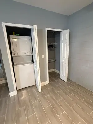 an empty room with a refrigerator and an open door at Cozy Modern Studio in Orlando