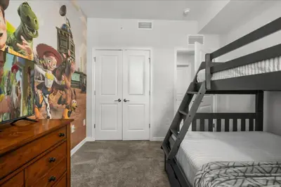 a bedroom with a bunk bed and a dresser at 3 Bedrooms 2 Bathrooms Storey Lake 3141-306 in Kissimmee
