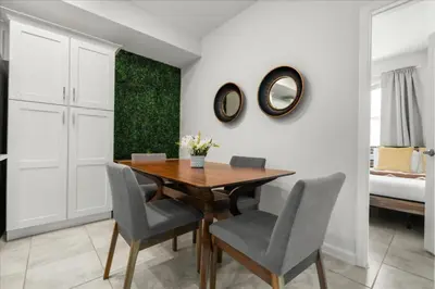 a dining room with a wooden table and chairs at 3 Bedrooms 2 Bathrooms Storey Lake 3141-306 in Kissimmee