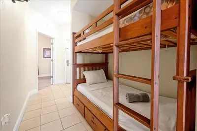 a bedroom with two bunk beds and a hallway at Luxurious Condo near DisneyLand in Orlando