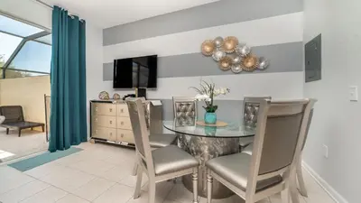 a dining room with a glass table and chairs at MSW2537 in Orlando