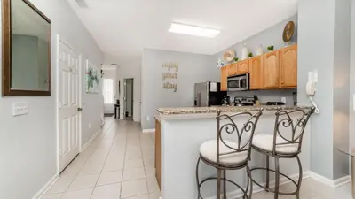 a kitchen with a counter and two stools at MSW2537 in Orlando