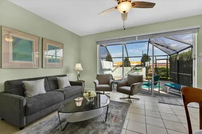 a living room with a couch and a table at MSW2549 in Orlando