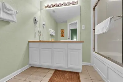 a bathroom with a white vanity and a mirror at MSW2549 in Orlando