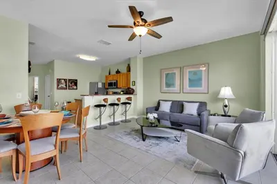 a living room and dining room with a ceiling fan at MSW2549 in Orlando