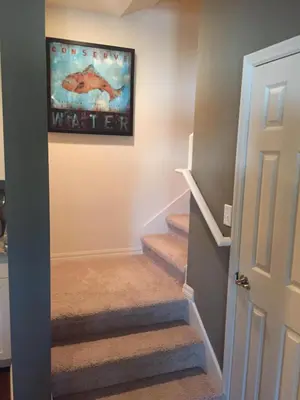a staircase in a home with a painting on the wall at 3BR Townhome West Lucaya Resort Close to Disney in Kissimmee