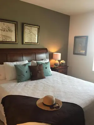 a hat is sitting on a bed in a bedroom at 3BR Townhome West Lucaya Resort Close to Disney in Kissimmee