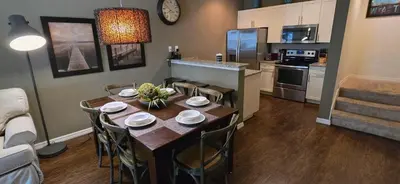 a kitchen and dining room with a table and chairs at 3BR Townhome West Lucaya Resort Close to Disney in Kissimmee