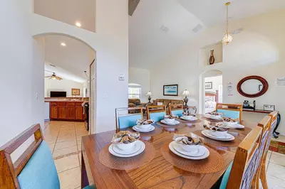 a dining room with a large wooden table with chairs at Great Location With Conservation Views in Orlando