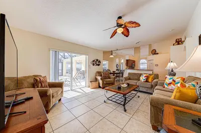 a living room with a couch and a table at Great Location With Conservation Views in Orlando