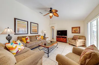 a living room with couches and a ceiling fan at Great Location With Conservation Views in Orlando