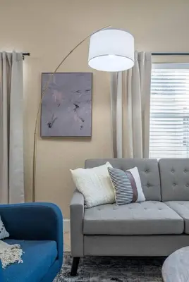 a living room with a couch and a lamp at Large 3 bedroom with King Bed in Orlando