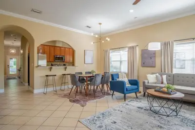 a living room with a couch and a table at Large 3 bedroom with King Bed in Orlando