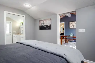 a bedroom with a large bed and a dining room at Massive 3 bedroom with large backyard in Orlando