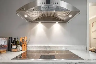 a kitchen with a hood over a kitchen sink at Massive 3 bedroom with large backyard in Orlando