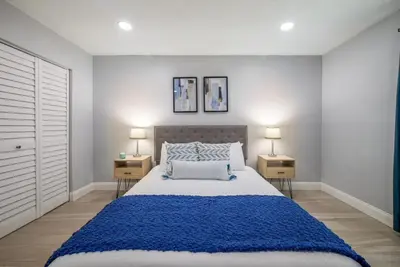 a bedroom with a large bed and two night stands at Large 2 bedroom with King bed and Patio in Orlando