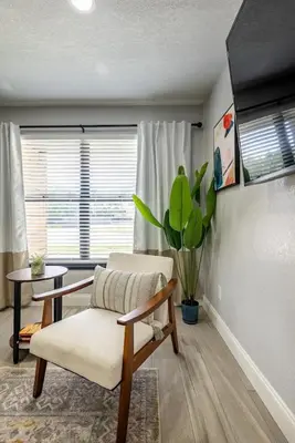 a living room with a chair and a table at Large 2 bedroom with King bed and Patio in Orlando