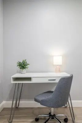 a white desk with a chair and a lamp at Large 2 bedroom with King bed and Patio in Orlando