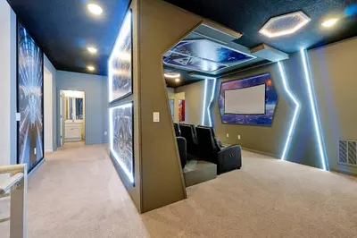 a room with a room with a tv and a hallway at Luxury and Sophisticated 15 BR ensuite in Kissimmee