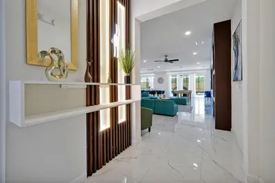 a hallway with a door leading into a living room at Luxury and Sophisticated 15 BR ensuite in Kissimmee