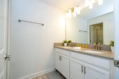 a bathroom with two sinks and a mirror at Beautiful 4 BR close to Disney in Kissimmee
