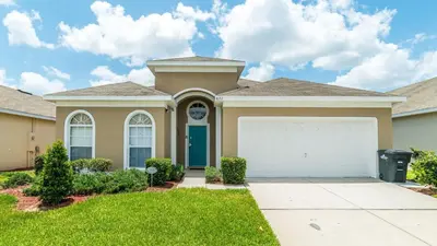 a house with a garage in front of it at FP8157 - Windsor Palms Resort 4 Bedroom Home With Game Room in Kissimmee