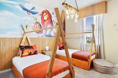 a bedroom with two bunk beds and a disney mural at Upstay 15BR Villa w Games Room, Pool & Cinema in Kissimmee