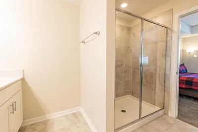 a bathroom with a shower with a glass door at Comfortable 2BR Condo w Lake Views in Kissimmee