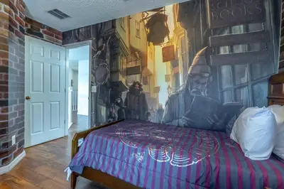 a bedroom with a bed with a painting on the wall at 8512 Emerald Island in Kissimmee