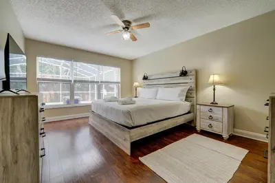 a bedroom with a bed and a ceiling fan at Sun Kissed Pool Home in Kissimmee in Kissimmee