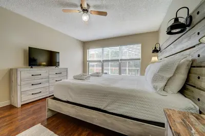 a bedroom with a large bed and a window at Sun Kissed Pool Home in Kissimmee in Kissimmee