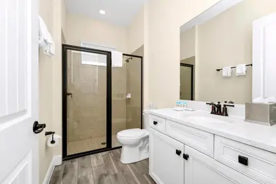 a bathroom with a toilet and a sink and a shower at Coral Cottage With Private Pool Near Disney With Margaritaville Resort And Island H20 Waterpark Access - 2946Sr in Orlando