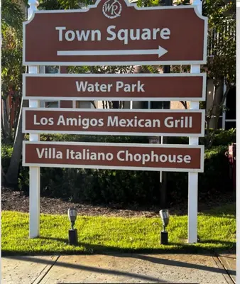 a sign for a water park with several signs at Westgate Towers in Orlando