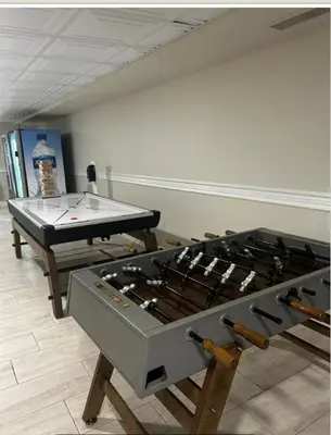 two ping pong tables in a room with a stove at Westgate Towers in Orlando