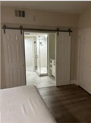 an empty room with two doors and a bedroom at Westgate Towers in Orlando