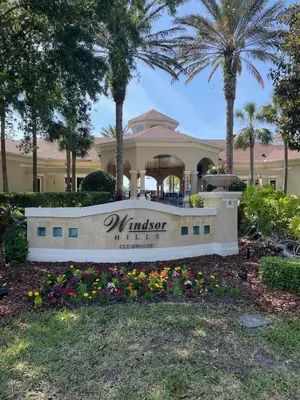 a sign in front of a building with palm trees at Family Friendly II in Orlando