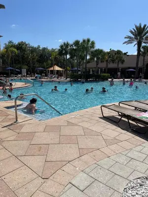 a group of people swimming in a swimming pool at Family Friendly II in Orlando