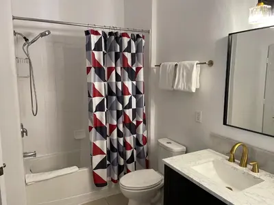 a bathroom with a toilet and a shower curtain at Family Friendly II in Orlando