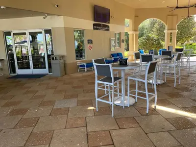 a patio with tables and chairs in a building at Family Friendly II in Orlando