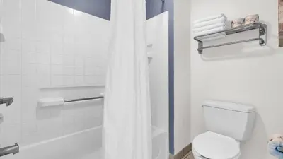 a bathroom with a white toilet and a shower at Condo with Hot Tub and Pool in Orlando