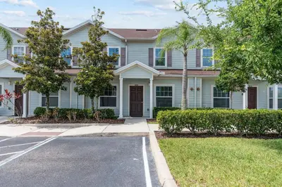 a large white house with a parking lot at Amzing location 3BDR House - 8980 in Kissimmee