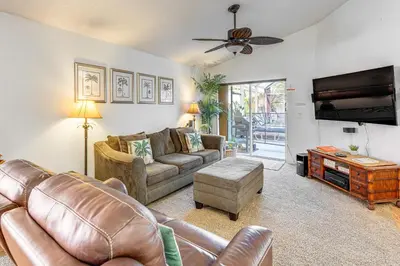 a living room with a couch and a tv at 3 Mi to Disney World Poolside Oasis with Game Room in Kissimmee