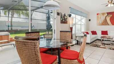 a dining room with a glass table and chairs at Windsor Palms Resort Vacation Home in Kissimmee