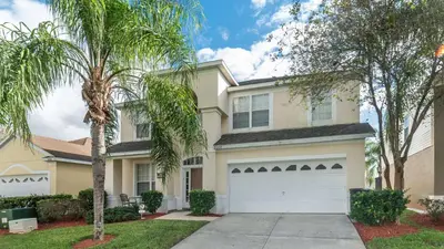 a house with palm trees in front of it at Windsor Palms Resort Vacation Home in Kissimmee