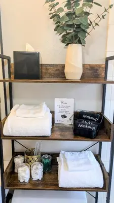 a shelf with towels and a potted plant on it at Modern 3BR Home 10 Min from MCO in Orlando
