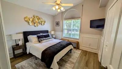 a bedroom with a bed and a ceiling fan at Modern 3BR Home 10 Min from MCO in Orlando