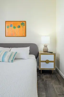 a bedroom with a bed and a table with a lamp at 4862 Cayview Avenue 208 in Orlando