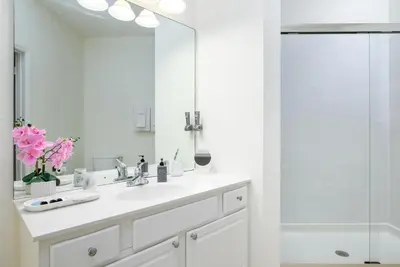 a white bathroom with a sink and a shower at 4862 Cayview Avenue 208 in Orlando