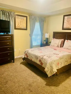 a bedroom with a bed and a dresser and a television at Paraíso Magico Getaway 5152 in Kissimmee